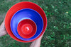 Nested set of handblown glass bowls from Serve Kindness in Red and Cobalt colors