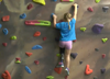 Girl with prosthetic leg from 50Legs climbing a rock wall