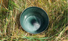 A Smoke colored handblown glass bowl that is grey green in color. Made in the USA from Serve Kindness.